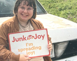 Donor holding JunkForJoy sign